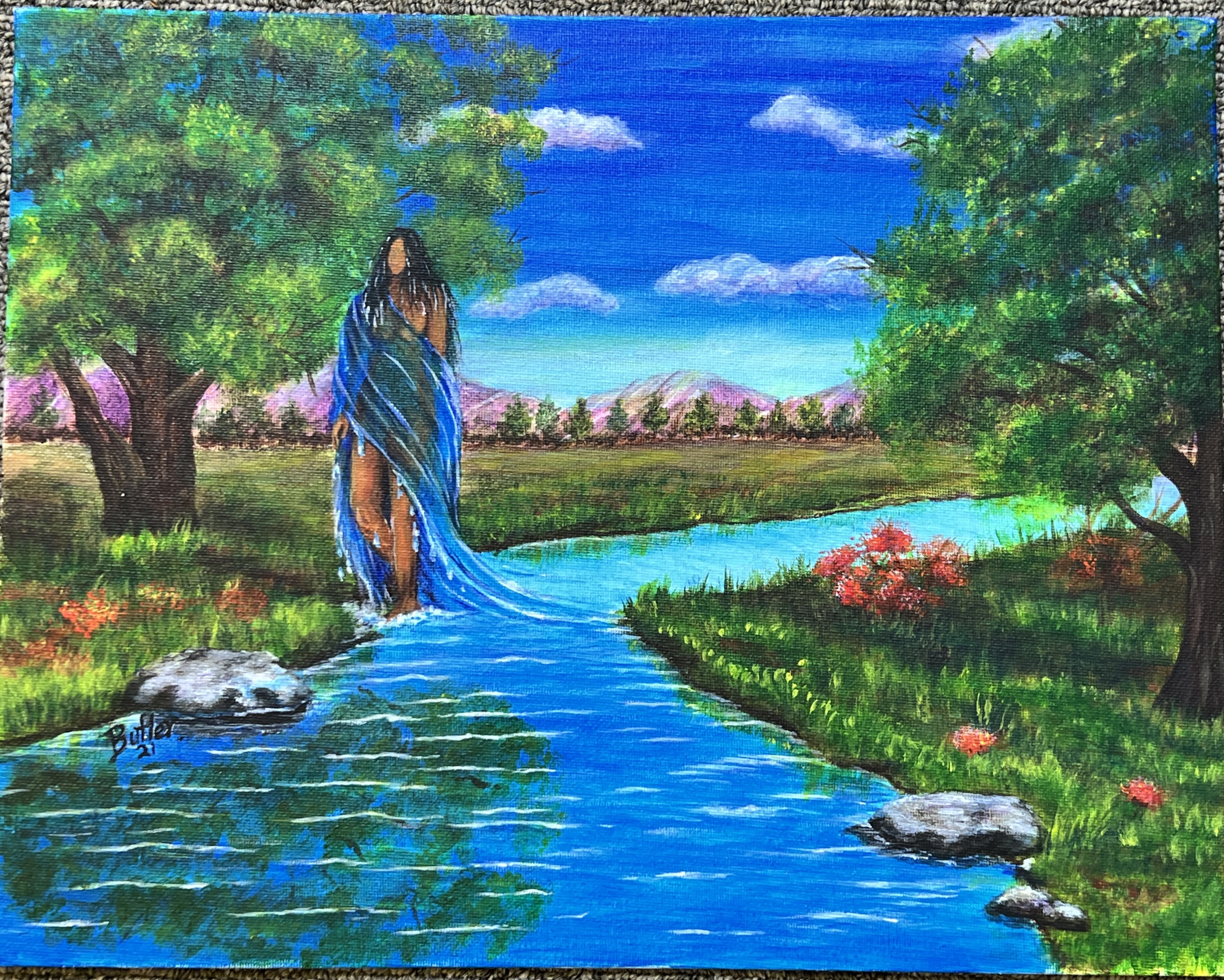 Landscape background with a stream running through the center. A naked body walks through the stream, wrapped in the water.