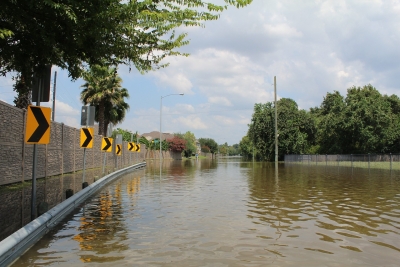 A roadway severely flooded after a hurricane.