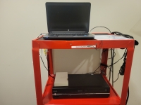 red cart with laptop and vcr player