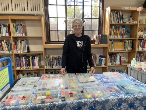 Photo of Joan Lloyd in front of beads