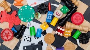 assortment of game pieces over a chess board and board game board