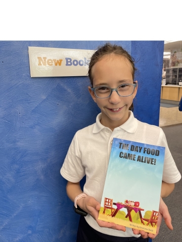 child holding book titles "the day food came alive"