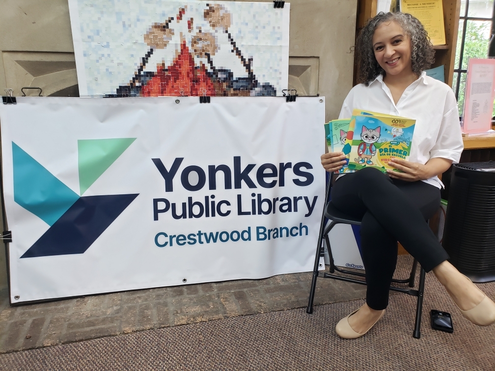 Image of Prima reading one of her books