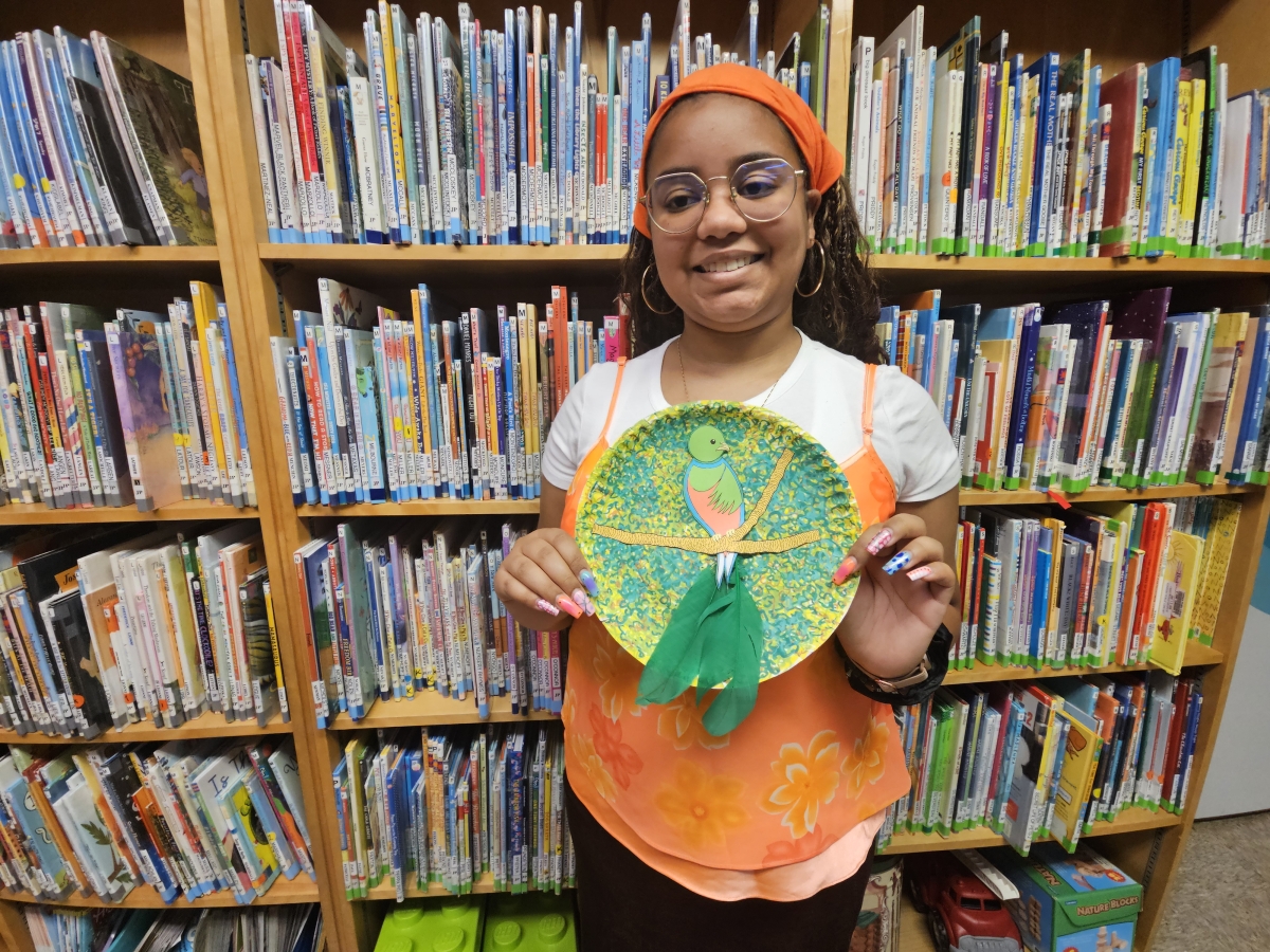 Artist Say Marte holding a paper plate Quetzal