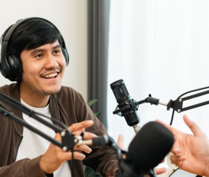 image of person recording an interview at a microphone