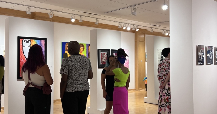Patrons viewing works on display during opening reception of Radical Joy